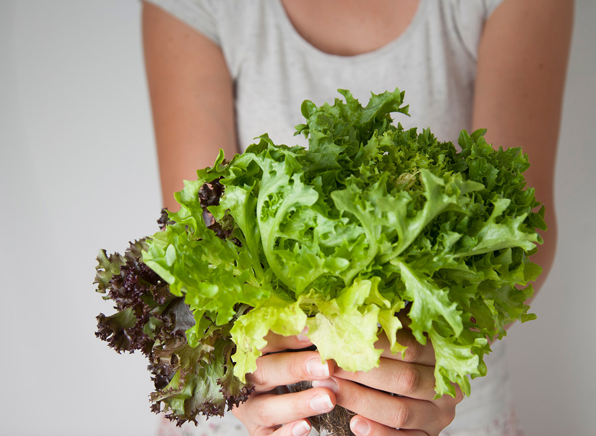 holding green leafy vegetables