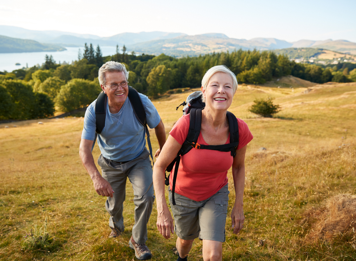 happy seniors who hate exercising on scenic walk