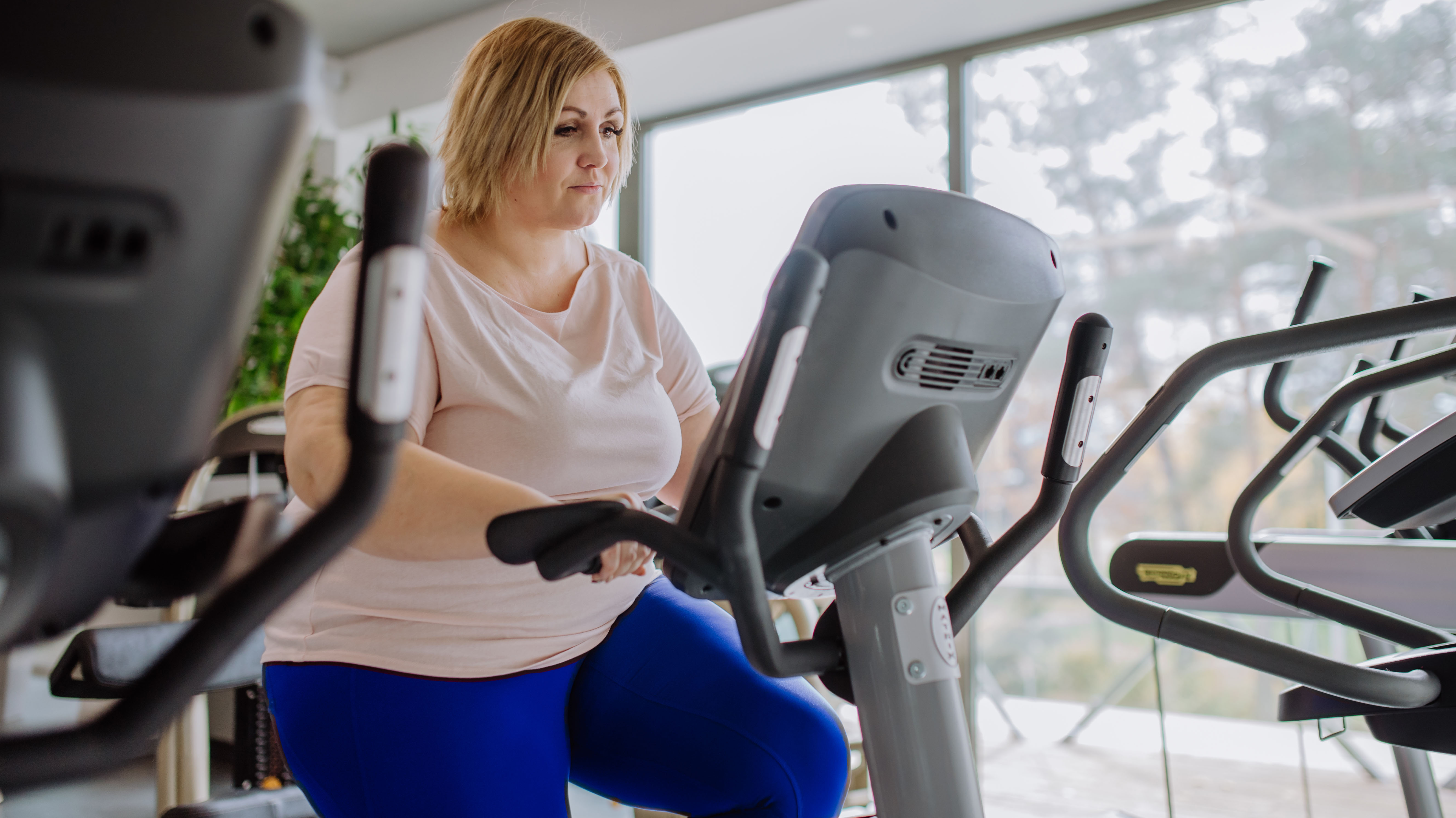 Woman on stationary bike in gym