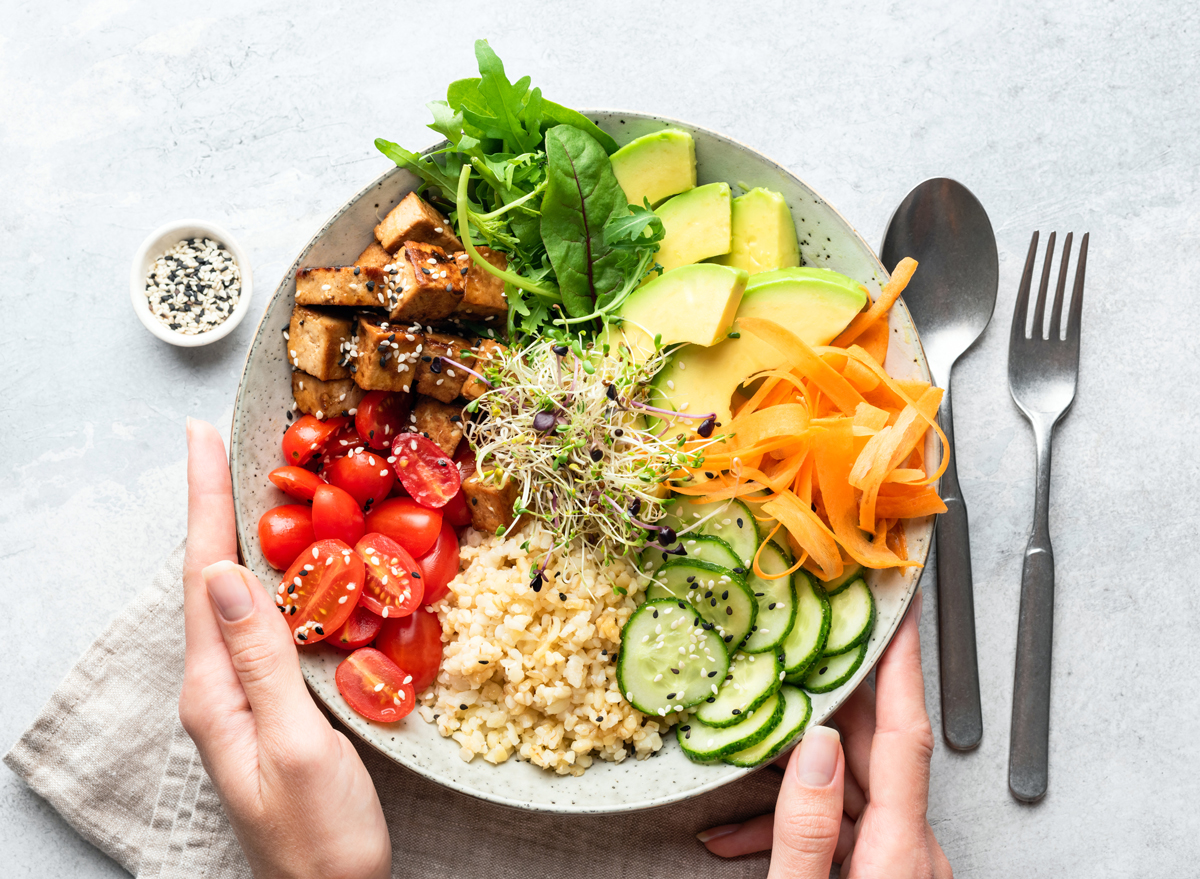 Healthy Plant-Based Bowl Tomatoes Carrots Avocado Brown Rice Cucumbers Leafy Greens