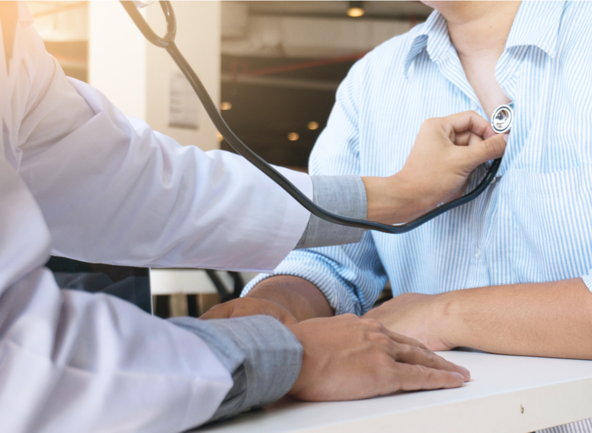 doctor checking heart with stethoscope