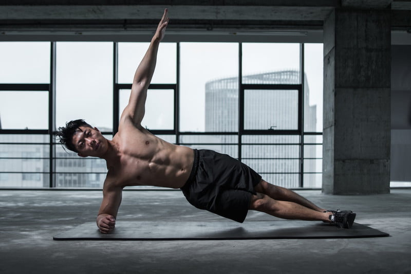 Man doing side plank.