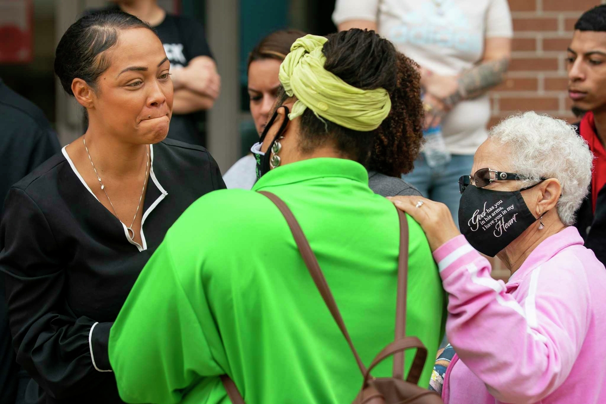 Dallas Garcia, left, talks with Cynthia Cole, in green, following a November press conference outside the Harris County Jail in Houston. Garcia was discussing her son, Fred Harris, who had special needs and was killed by a fellow inmate the month prior.