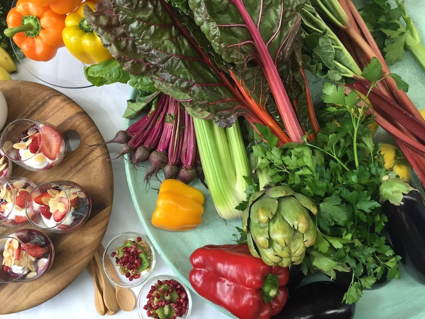 A table of healthy food, including fruits, vegetables and healthy snacks.