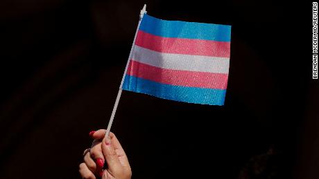 Someone holds up a flag during a rally to protest the Trump administration's transgender proposal at City Hall, New York.