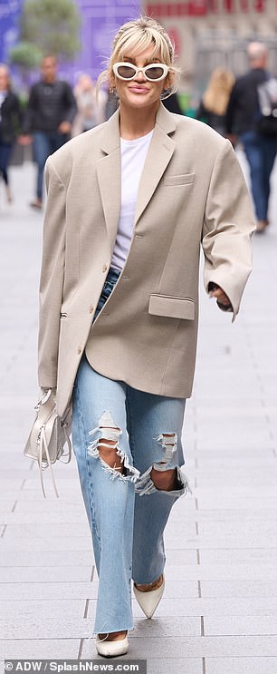 Out of this world: She looked sensational in a stone coat that she paired with a white T-shirt and faded jeans.