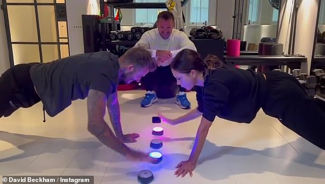 'Let the games begin': The couple turned on their colored light as their trainer Bobby Rich looked on in their home gym