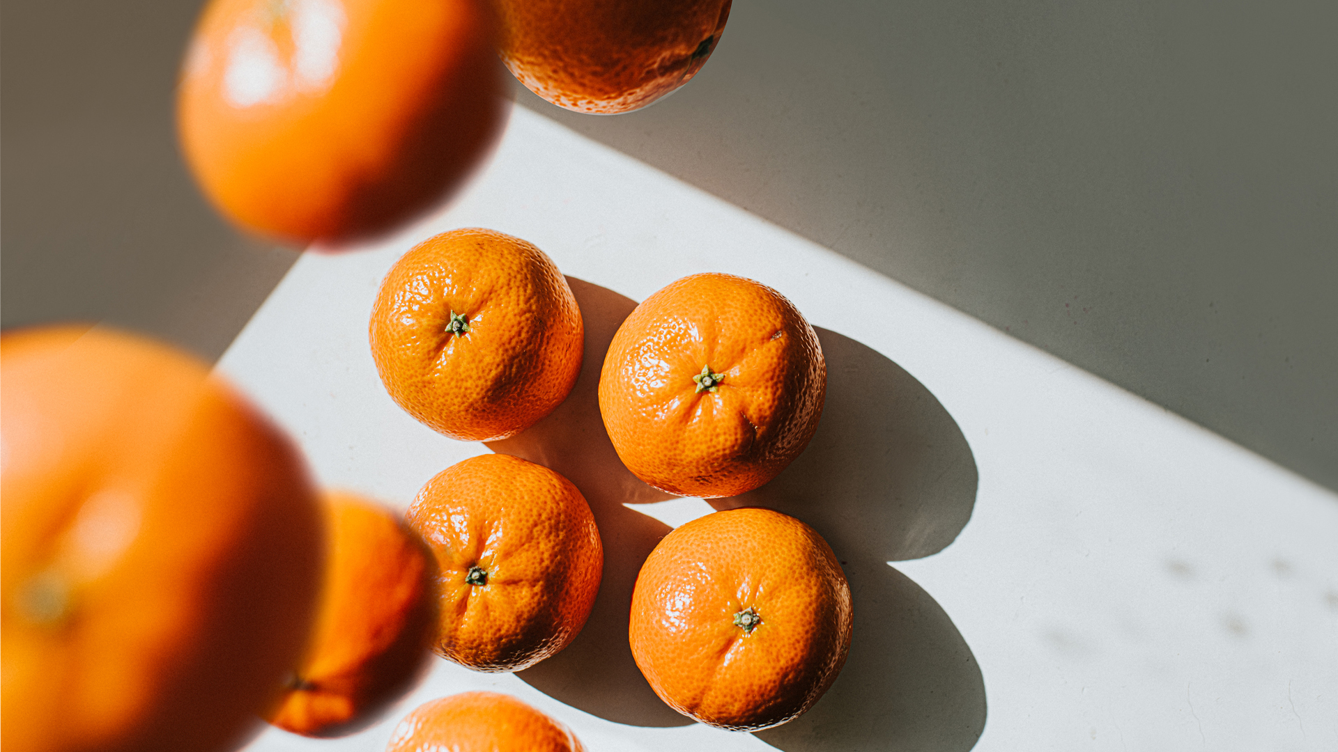 oranges falling on a counter